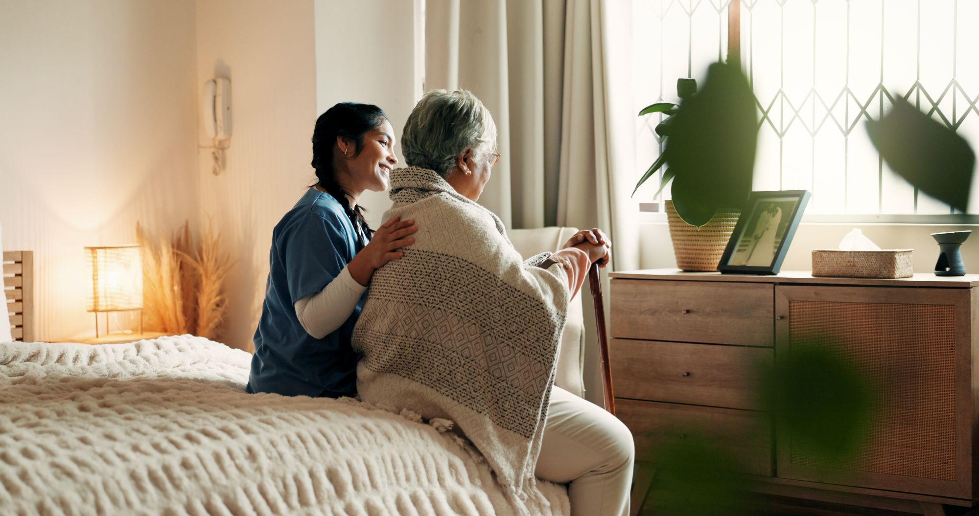 Caregiver supporting a senior at home with in-home memory care and wellness tracking in Phoenix and Tucson